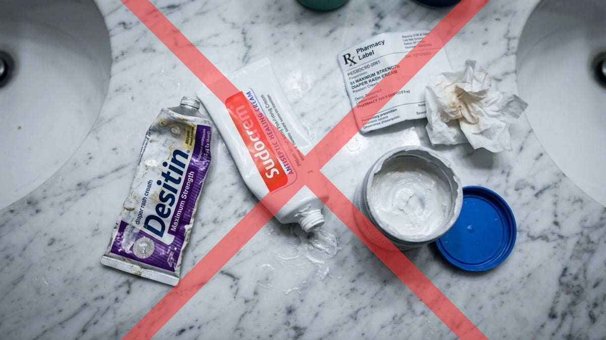 Prescription rash cream, Sudocrem, and Desitin crossed out on a bathroom counter